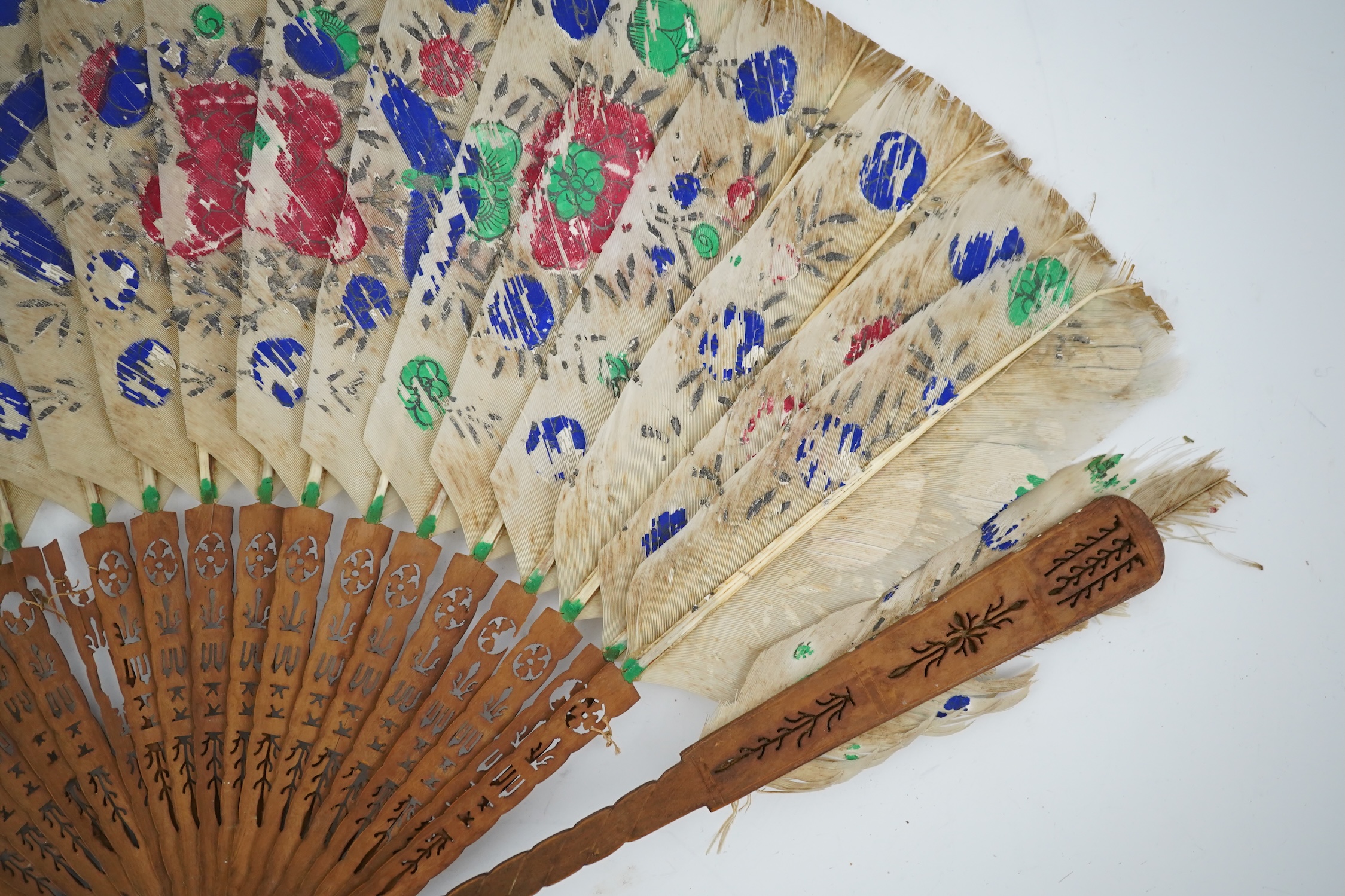 Three 19th century Chinese feather fans: One a carved bone brise black feather fan together with two similar carved sandalwood feather fans, two fans have hand painted decoration on the feathers both sides, the pink feat